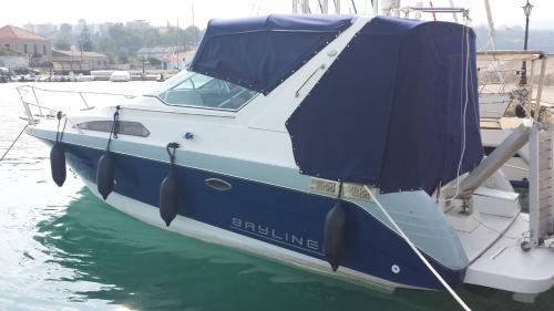 a blue and white boat sitting in the water at HOUSE SUITES DOMAINE in Rizómilos