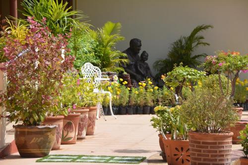 a group of potted plants in front of a statue at Baan Sabaijai Resort in That Phanom