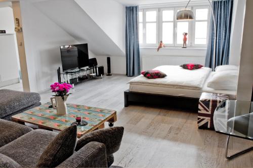 a living room with a bed and a couch at Royal Court Legerova in Prague