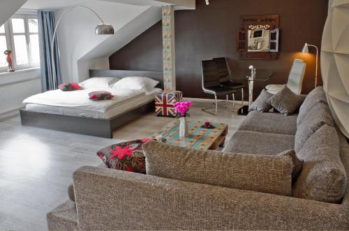 a living room with a couch and a bed at Royal Court Legerova in Prague