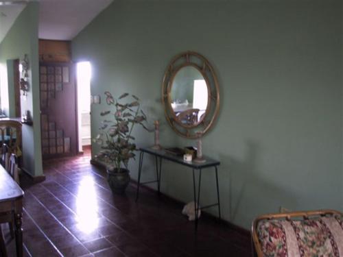 a room with a mirror and a table with a plant at Dre Broeders Apartments Juan Dolio in Juan Dolio