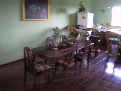 a dining room with a wooden table and chairs at Dre Broeders Apartments Juan Dolio in Juan Dolio