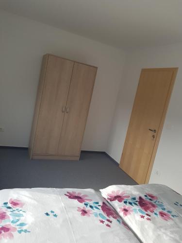 a bedroom with two wooden cabinets and a bed at Apartmaji Janković in Logatec