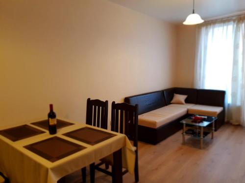 a living room with a couch and a table at Cosy Apartment - City Centre in Blagoevgrad