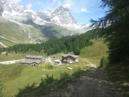 a view of a mountain from a dirt road at Baita Layet in Breuil-Cervinia