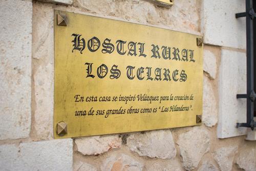 a sign on the side of a building at Hostal Rural Los Telares in Pastrana