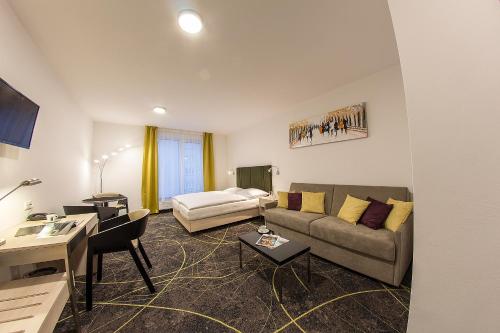 a living room with a couch and a table at Hotel Valcha in Prague