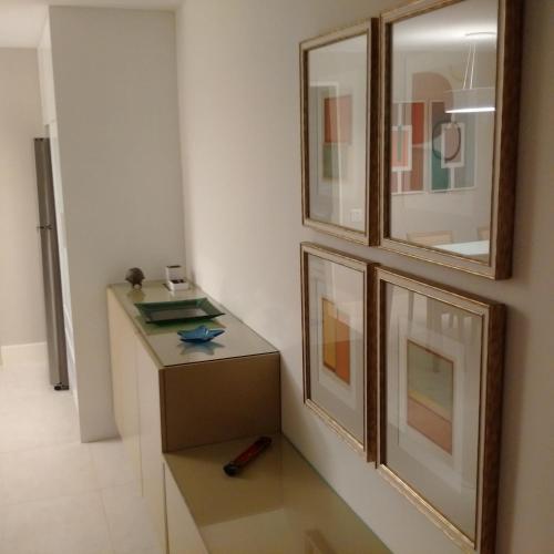 a room with a table and some pictures on the wall at Ocean Flat in Rio de Janeiro
