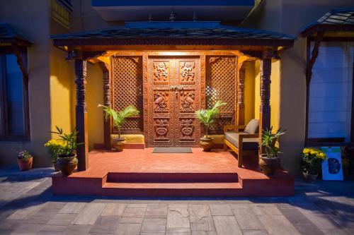 an entrance to a building with a wooden door at The Lapsi Tree in Nagarkot