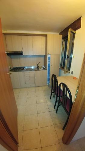 a kitchen with a table and chairs in a room at Residence Parco del Sole in Rodi Garganico