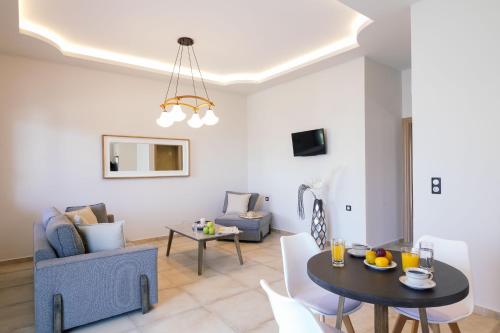 a living room with a table and a couch at Belvedere Luxury Apartments & Spa in Plakias
