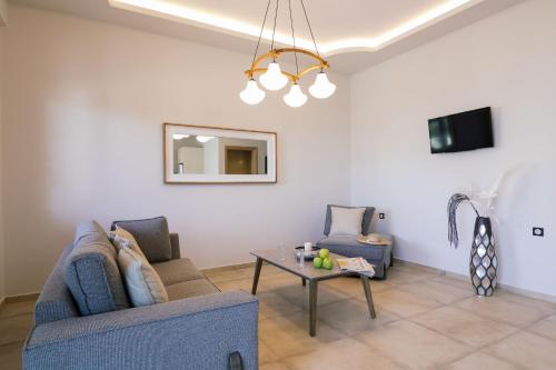 a living room with two chairs and a table at Belvedere Luxury Apartments & Spa in Plakias