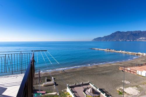 a view of the beach from the balcony of a house at On the beach Sea-view&Kitchen In Room in Salerno