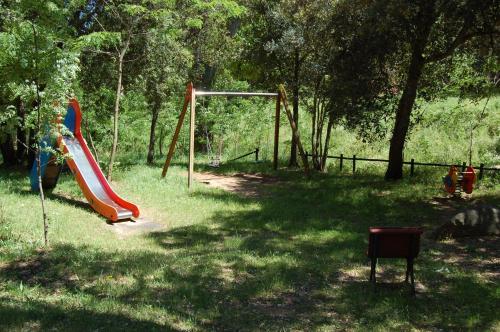 a park with a playground with a slide at Apartamentos Cala Salions in Tossa de Mar