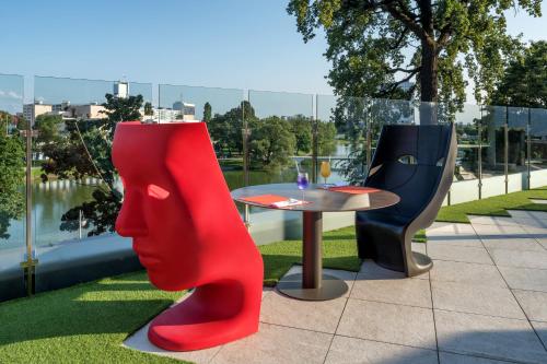 a table and chairs with a view of the water at Crystal House Suite Hotel & SPA in Kaliningrad