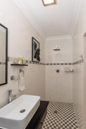 a white bathroom with a sink and a shower at Montagu Four Seasons in Montagu