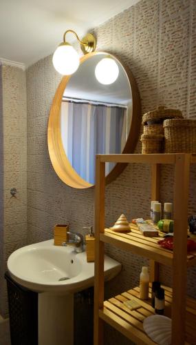 a bathroom with a sink and a mirror at Mezapos Villa Makrina in Mézapos
