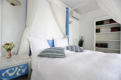 a bedroom with a blue and white bed with pillows at Pensiune-Restaurant Tara Luanei in Sărata-Monteoru