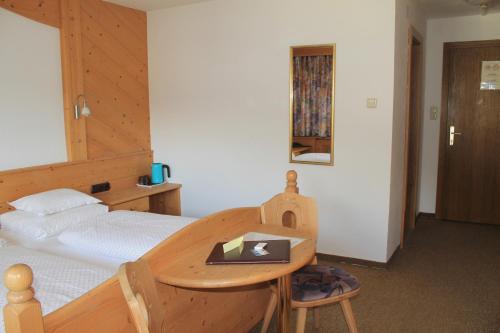 a bedroom with a bed and a table with a laptop on it at Martinshof in Obergurgl