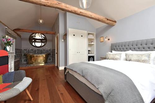 a bedroom with a large bed and a fireplace at The Mill, Long Melford in Long Melford