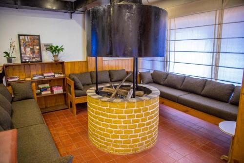a living room with a couch and a fire place at The Lapsi Tree in Nagarkot