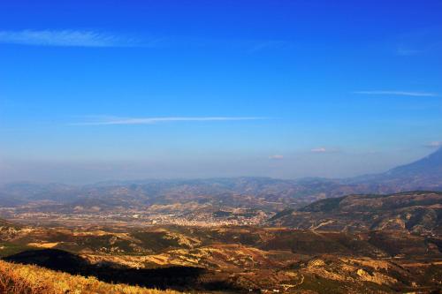 a view of a valley with mountains and a city at Quiet Villa Near Berat - Scenic Balcony & Garden in Berat