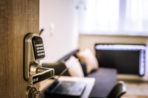 a door with a key unlocking a room with a couch at Pokoje4you in Koszalin