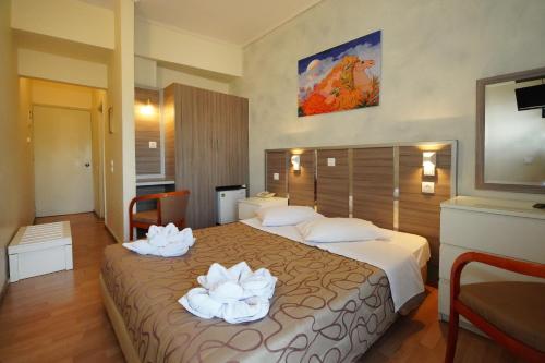a hotel room with a large bed with towels on it at Socrates Hotel in Athens