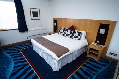 a hotel room with a large bed and a window at The Park Hotel in Kilmarnock