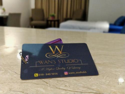 a business card sitting on top of a table at Wan's Studio (Kota Bharu City Point) in Kota Bharu