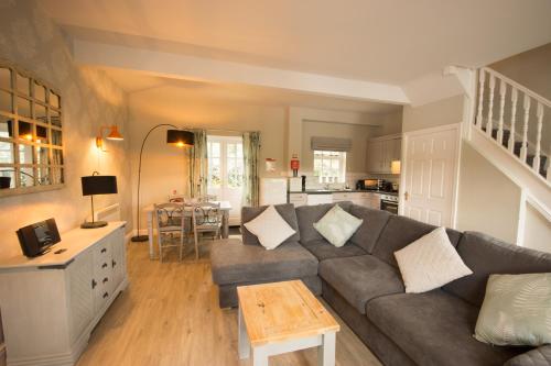 a living room with a couch and a table at Tissington Cottage- Darwin Lake Holiday Village in Matlock