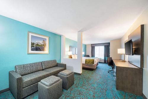 a hotel room with a couch and a bed at Comfort Inn & Suites Oklahoma City near Bricktown in Oklahoma City