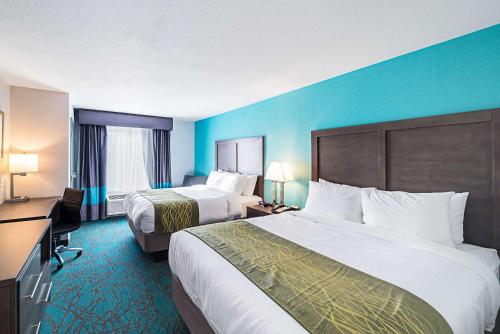 a hotel room with two beds and blue walls at Comfort Inn & Suites Oklahoma City near Bricktown in Oklahoma City