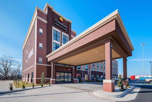 a large brick building with a sign on it at Comfort Inn & Suites Oklahoma City near Bricktown in Oklahoma City