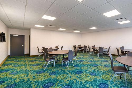 a conference room with tables and chairs on a carpet at Comfort Inn & Suites Oklahoma City near Bricktown in Oklahoma City