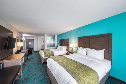 a hotel room with two beds and a blue wall at Comfort Inn & Suites Oklahoma City near Bricktown in Oklahoma City