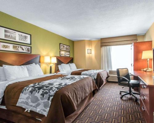 a hotel room with two beds and a desk at The Douillet by Demeure Hotels in Oklahoma City