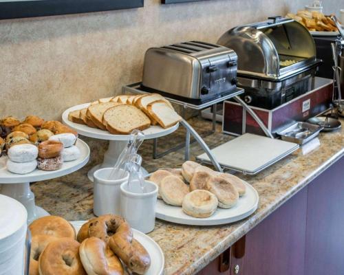 a counter with three plates of bread and pastries at Comfort Suites Portland Southwest in Portland