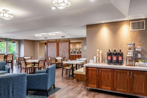 a restaurant with tables and chairs and a bar at Clarion Hotel Portland International Airport in Portland