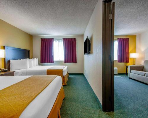 a hotel room with two beds and a couch at Quality Inn & Suites Springfield in Springfield