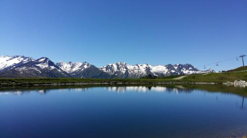 a view of a snow covered mountain range with a lake at Haus Roland in Zell am Ziller
