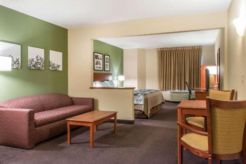 a hotel room with a couch and a bed at Sleep Inn & Suites Mountville in Mountville