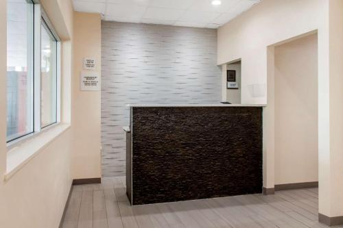 a lobby with a large stone wall in a building at Escape Inn Hershey in Hershey