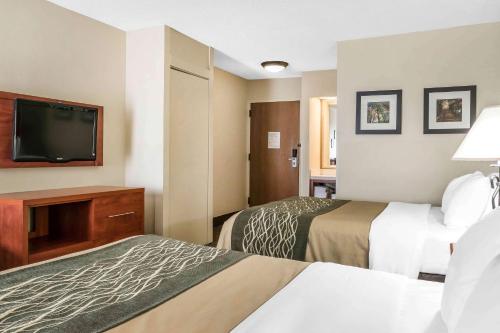 a hotel room with two beds and a flat screen tv at Comfort Inn Pine Grove I-81 Hershey Area in Pine Grove