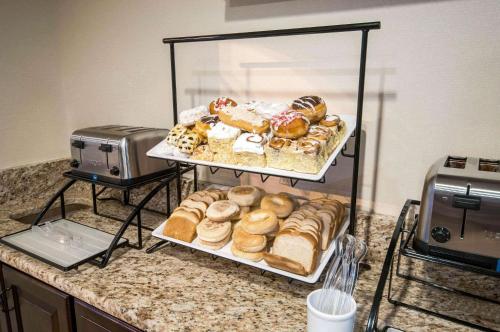 a display case filled with different types of donuts on a counter at Comfort Inn New Holland Amish Country in New Holland