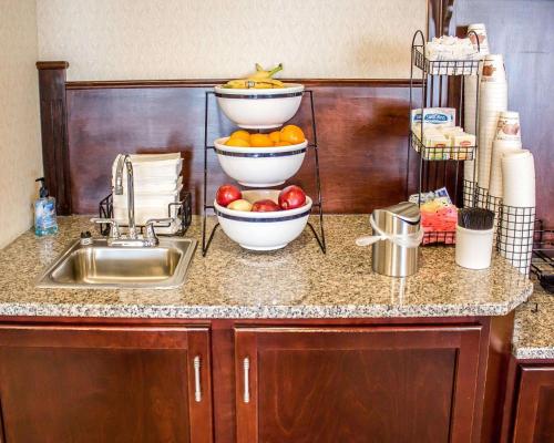 a kitchen counter with two bowls of fruit and a sink at Quality Inn in Clarion