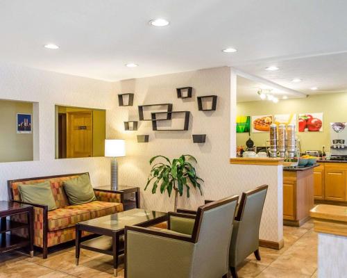 a living room with a couch and a table at Quality Inn Harrisburg - Hershey Area in Harrisburg