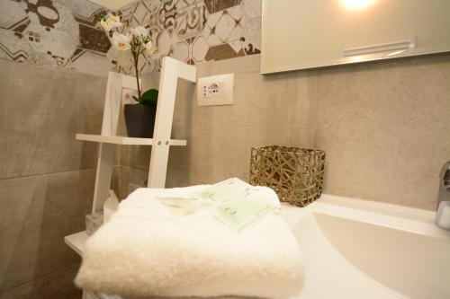 a bathroom with a white sink and a bath tub at La Dotta Apartments in Bologna