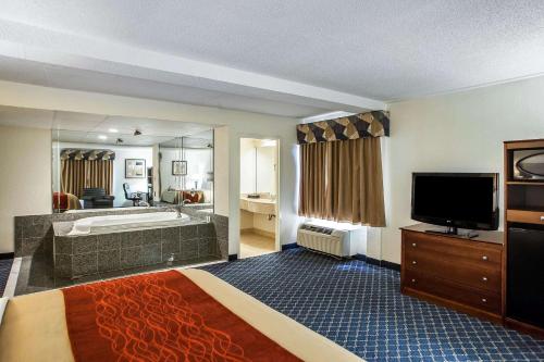 a large hotel room with a tub and a television at Comfort Inn Feasterville - Trevose in Trevose