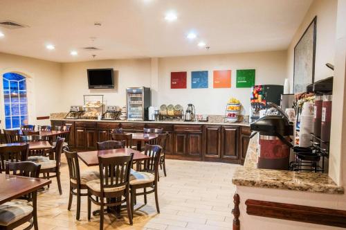 a restaurant with tables and chairs and a bar at Comfort Inn New Holland Amish Country in New Holland